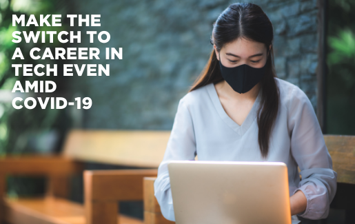 A woman working on a computer with a mask