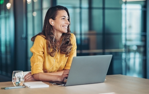 Brunette woman with yellow shirt smiling