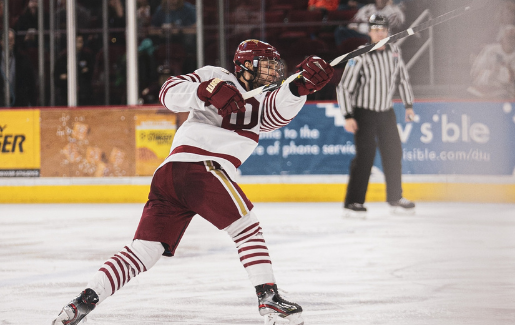 Hockey player shooting a goal