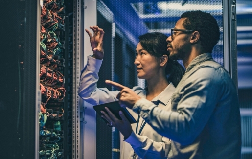 Male and female coworkers in a server room