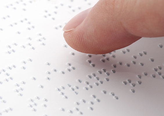 A person reading Braille