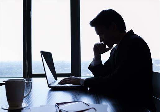 Man at desk in shadows