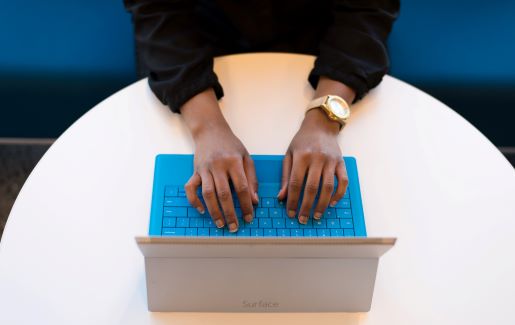 Hands typing hands typing on a tablet.