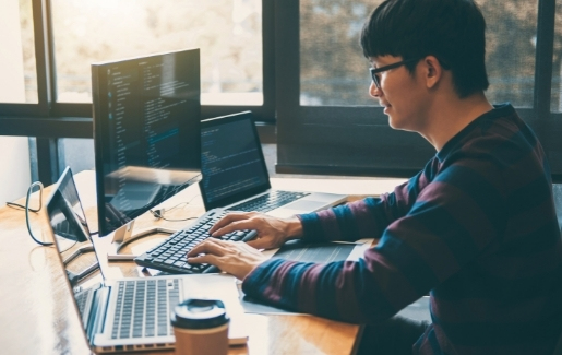 Male in striped sweater looking at code