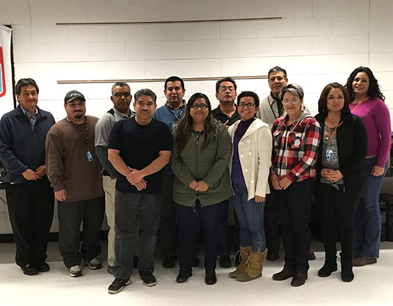 A group photo of the 13 students who received CompTIA certifications through the Community Education ESL Computer Maintenance Class