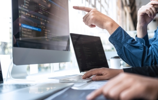 IT pro pointing at computer screen