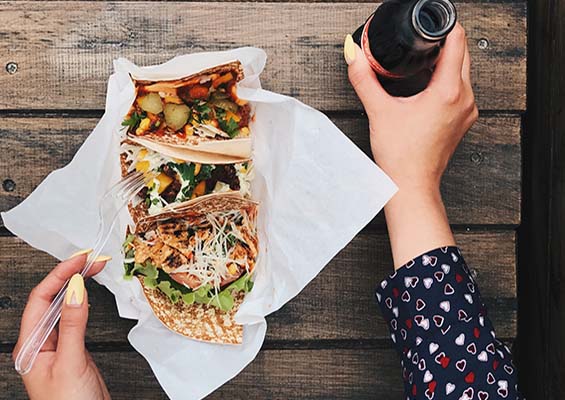 A woman eating fast-food tacos