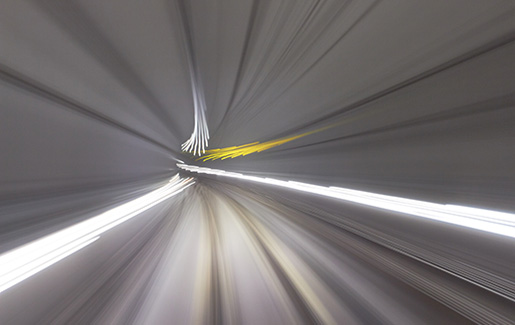 A time-lapse photo the shows beams of light meeting in the center of the photo