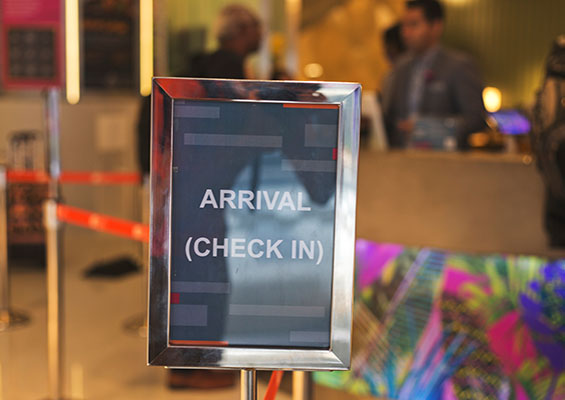A hotel lobby with a sign that says, 'Arrival Check-In'
