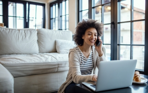 Woman working from home at coffee table.