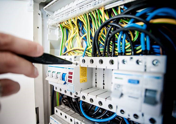 A person works on the cables in a server room