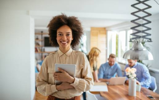 A woman smiles because she loves working in IT. It pays to work in IT: Salaries on the Rise