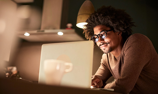 A man searches for jobs online on his laptop