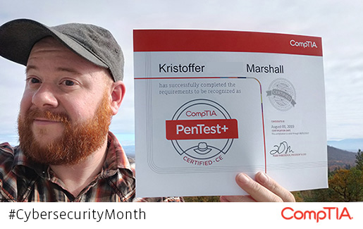 Kristoffer Mashall holds up his CompTIA PenTest+ certification