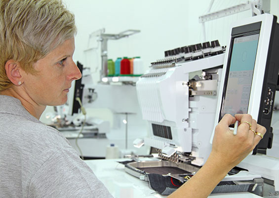 A woman works in a lab with machines