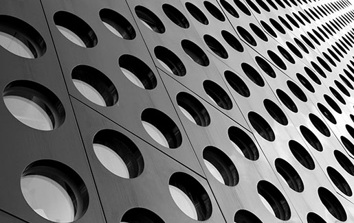Modern architecture with a repeated pattern of open circles on a black wall