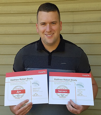 Matthew Brady holds up his CompTIA certifications