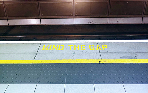 A photo from the London Tube that says "Mind the Gap"