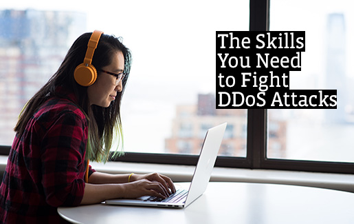 Mitigating DDoS Attacks IT Pro working on laptop at a cafe.