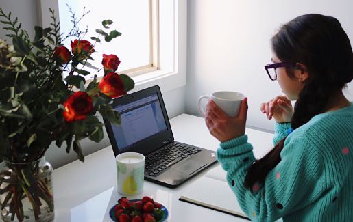 Girl studying for an Online IT exam at home from her desk.