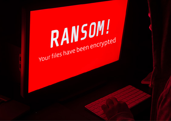 Ransomware A person at a computer sees a ransomware warning saying his files have been encrypted