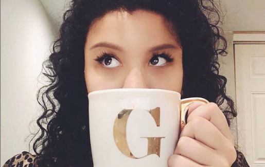 Gabriela Ariza drinking out of a G mug while studying for CompTIA Security+