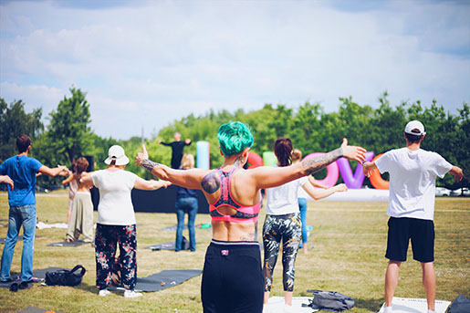 People do yoga in a park in Washington, D.C.