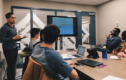 A DevOps team meets in a conference room