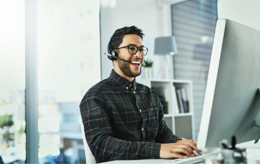 What-is-new-a Woman in white button down hovering over laptop