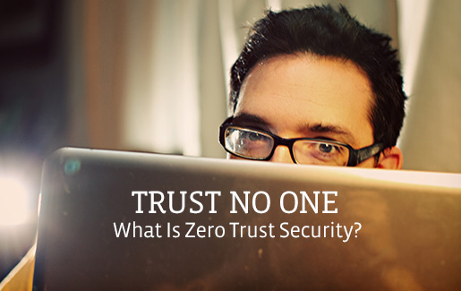 A man peeks over the top of his laptop, and the words read, "Trust no one: What is zero trust security?"