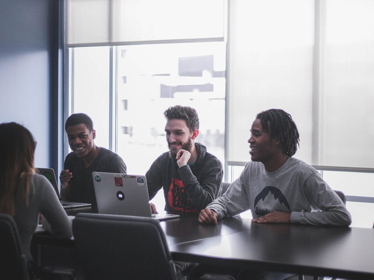 Four people having fun in a work meeting.