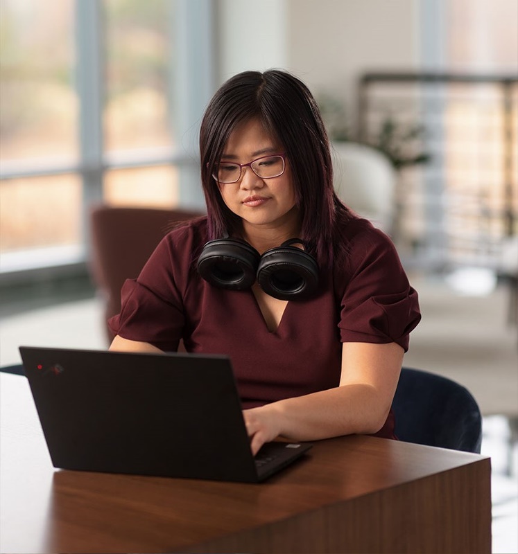 woman on laptop with headphones cropped