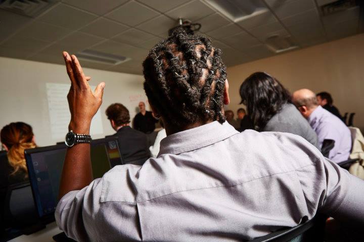 Photo of a man raising his hand in a class